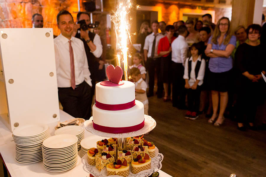 Hochzeitstorte wird angeschnitten mit Feuerwerk